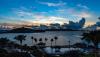 The sun peeks out from behind low clouds on a beautiful morning as it rises over St. John as seen from St. Thomas. 