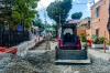 A red bulldozer on a partially paved road where underground powerlines are being builtduring hurricane irma recovery